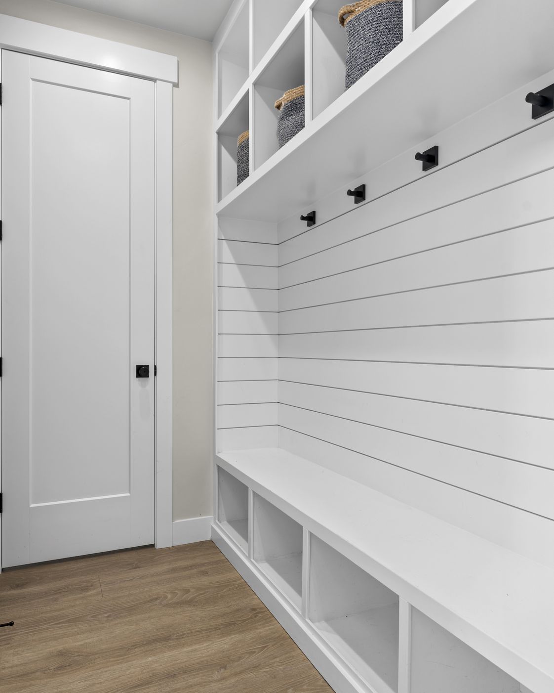 The mudroom entry at Vineyard Basecamp with a bench and hooks