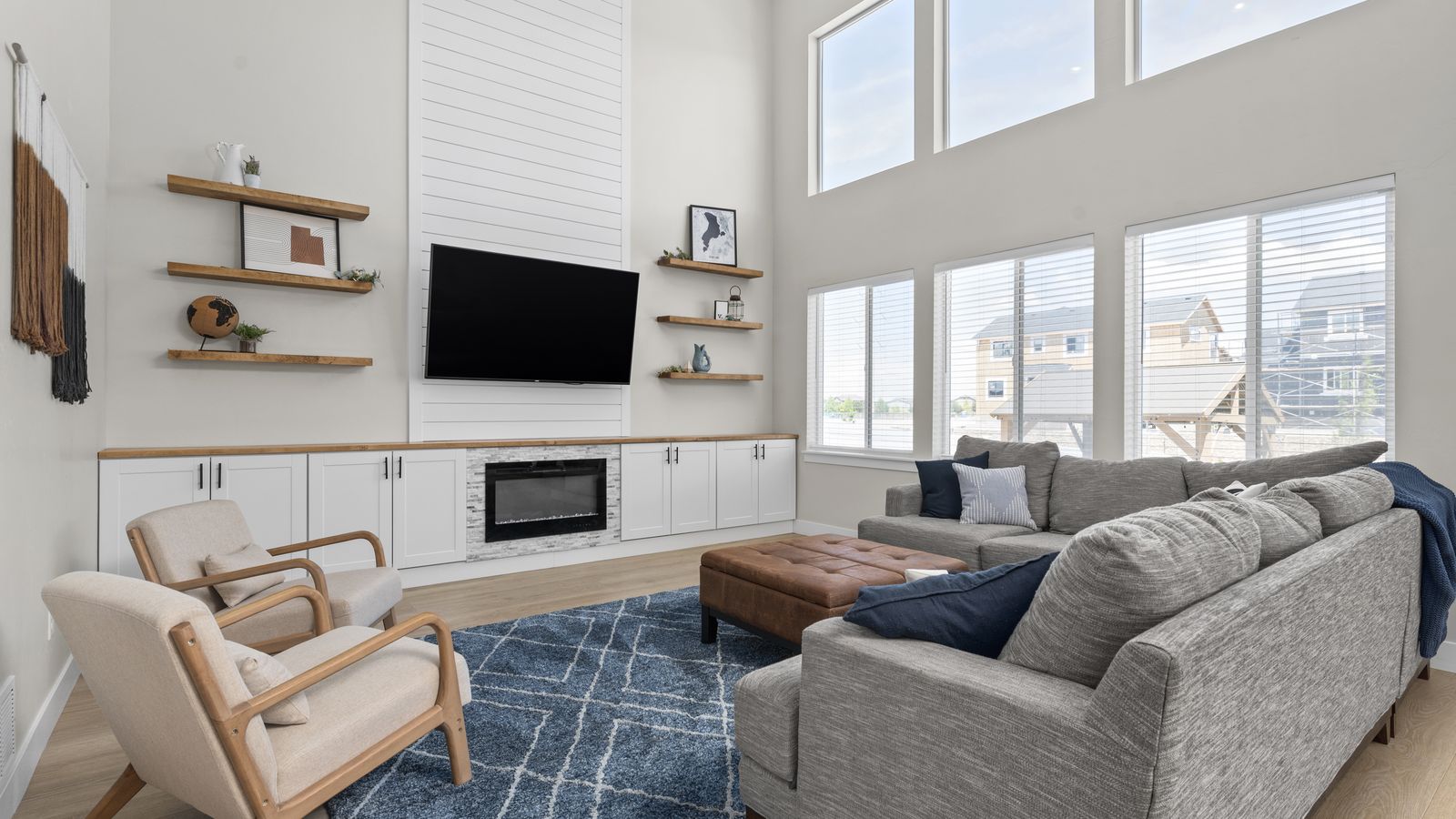 Vineyard Basecamp great room with a sectional, a blue rug, and tall windows