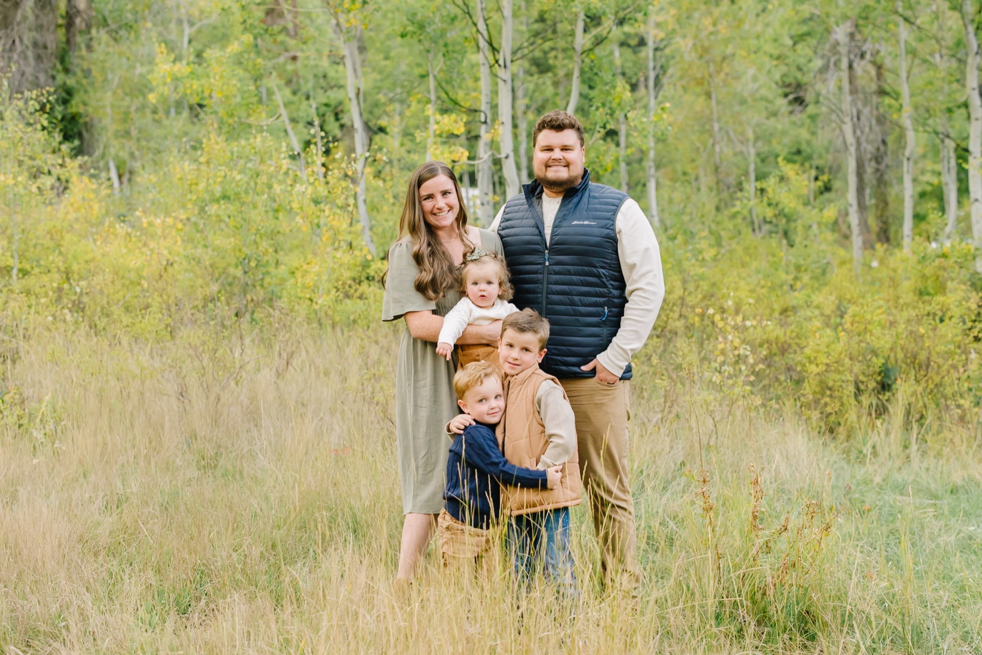 Junior and Mallory Vanden Brink with their children in an aspen grove
